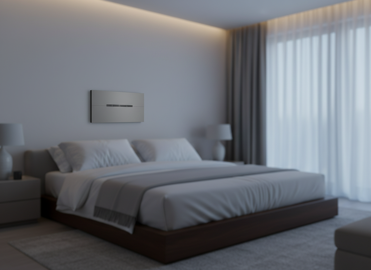 A luxurious bedroom in cool neutral tones, dominated by a low platform bed with crisp white bedding, subtly highlighted by a compact, near-silent climate unit recessed into the wall above the headboard. The unit’s front panel has a smooth, matte surface with a narrow, elegant air outlet slot. Indirect LED strip lighting runs along the ceiling edge, blending with faint blue-toned evening light filtering through sheer curtains. The atmosphere is tranquil and cocoon-like. Shot at eye level with photographic realism and a slight emphasis on the wall unit, the rest of the room softly defocused. The composition conveys night-time comfort, precise temperature control, and barely noticeable technology.